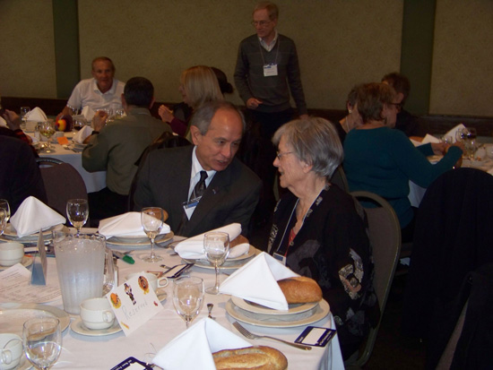 Two guest seated at luncheon table talking