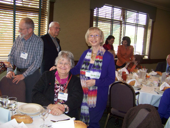Guest standing and seated at the luncheon 